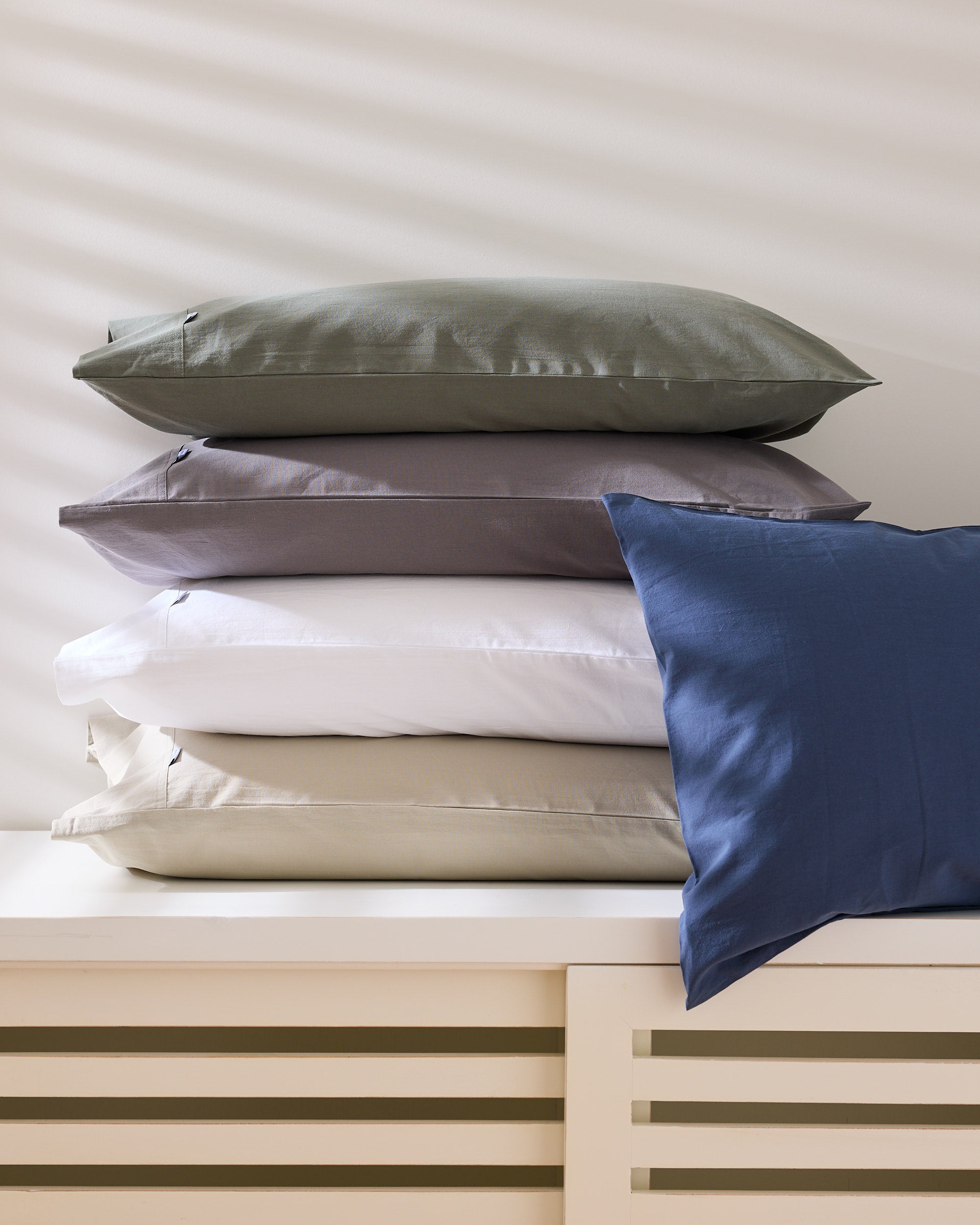 Royal Doulton Nelson pillowcases stacked in sage, grey, white, cream and blue