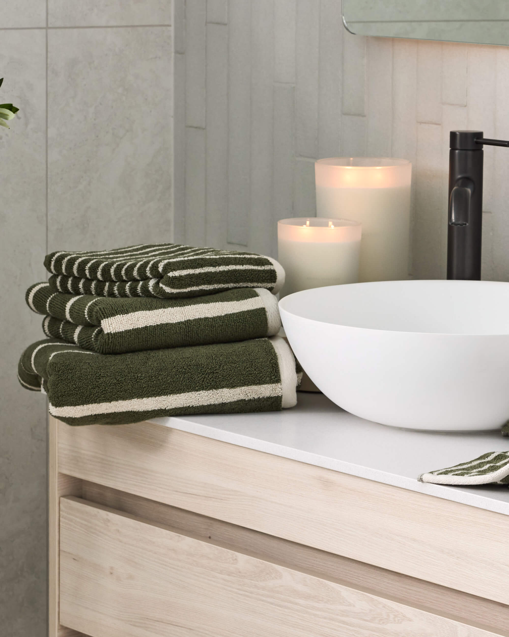 Royal Doulton Flynn Moss striped towels beside a white basin and candles