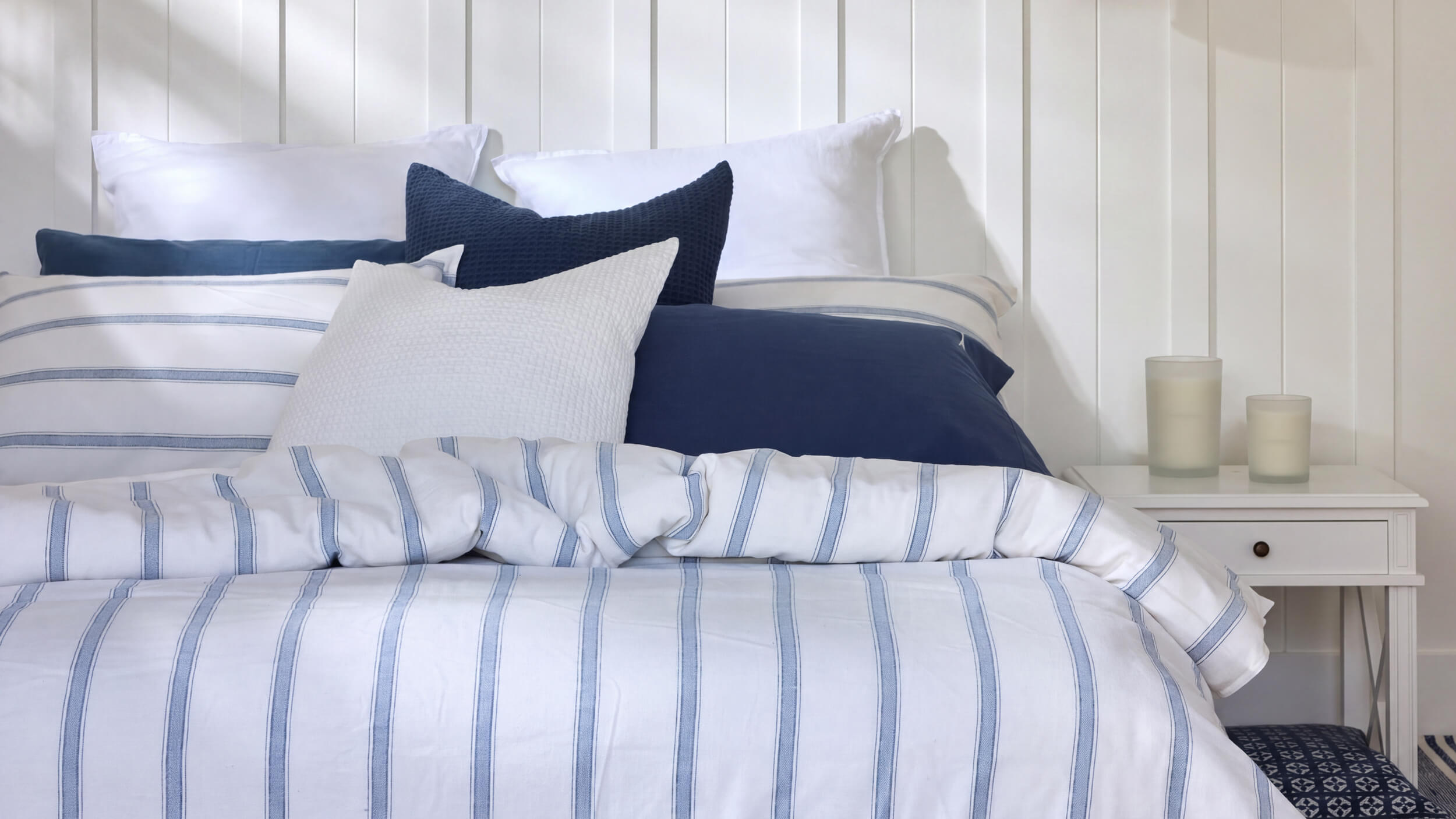 Royal Doulton Kate blue striped duvet cover styled with navy and white cushions
