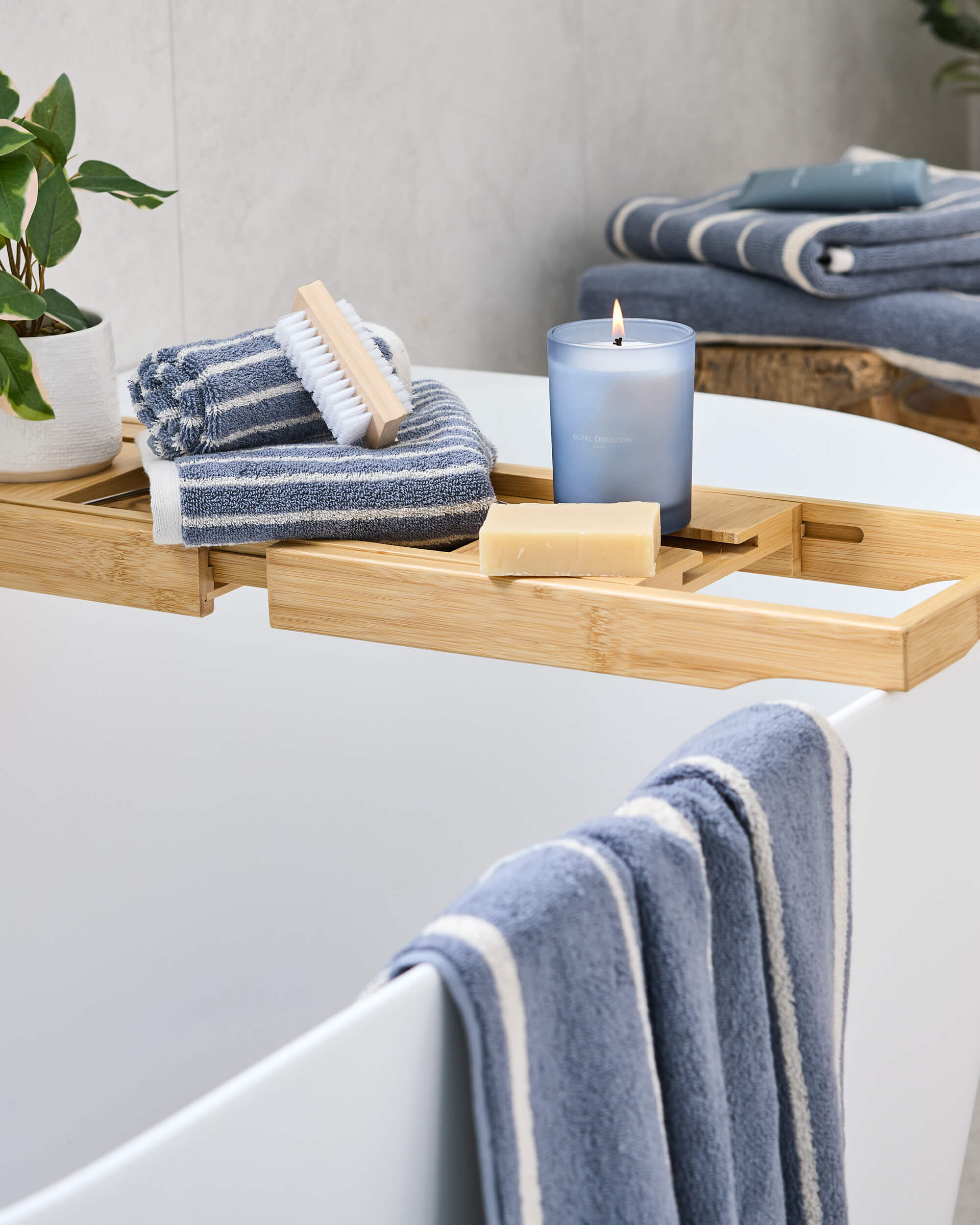 Royal Doulton Flynn Steel striped towels arranged on a bath and wooden tray
