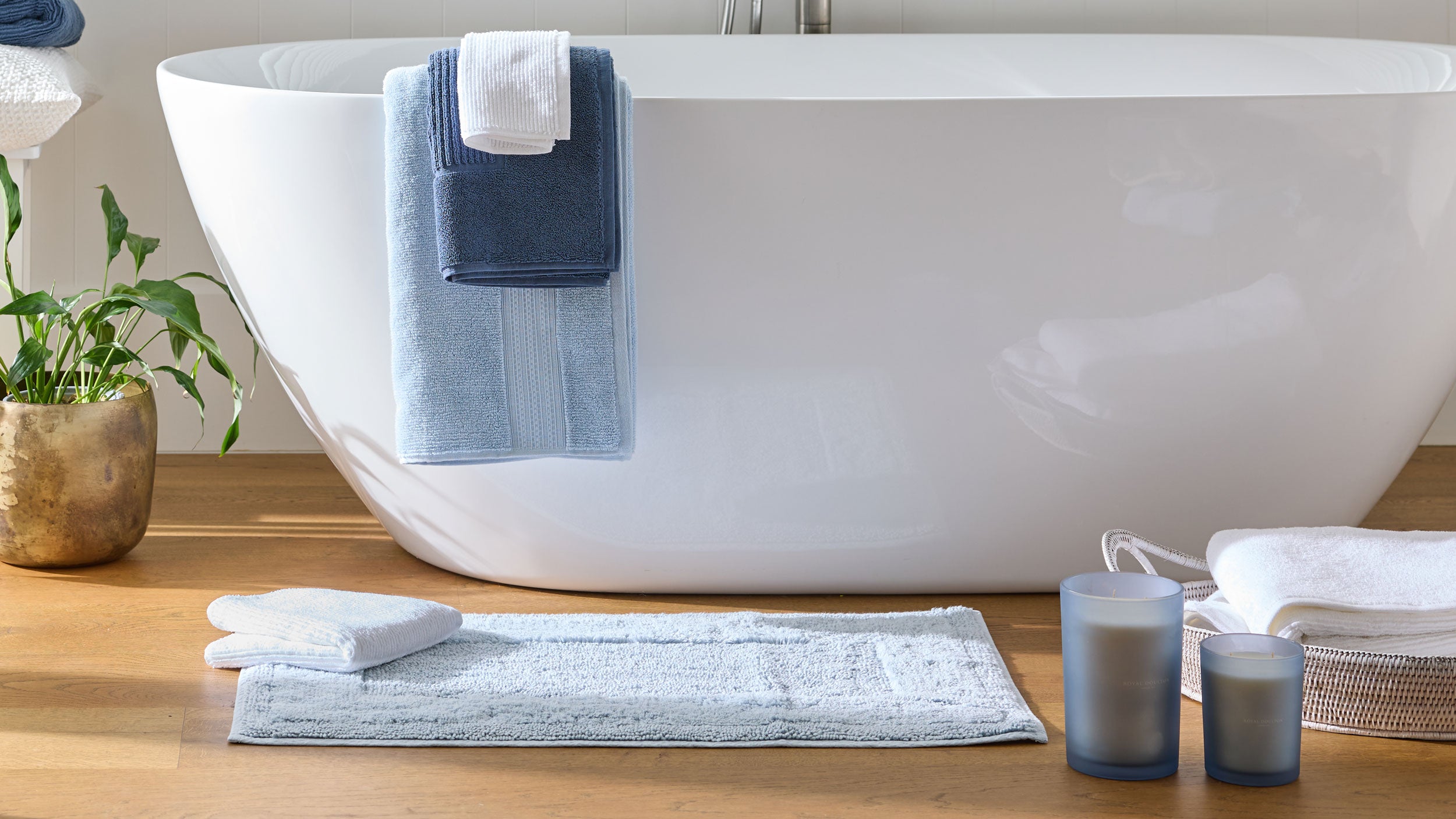 Royal Doulton Harlow pale blue bath mat beside a white freestanding bath