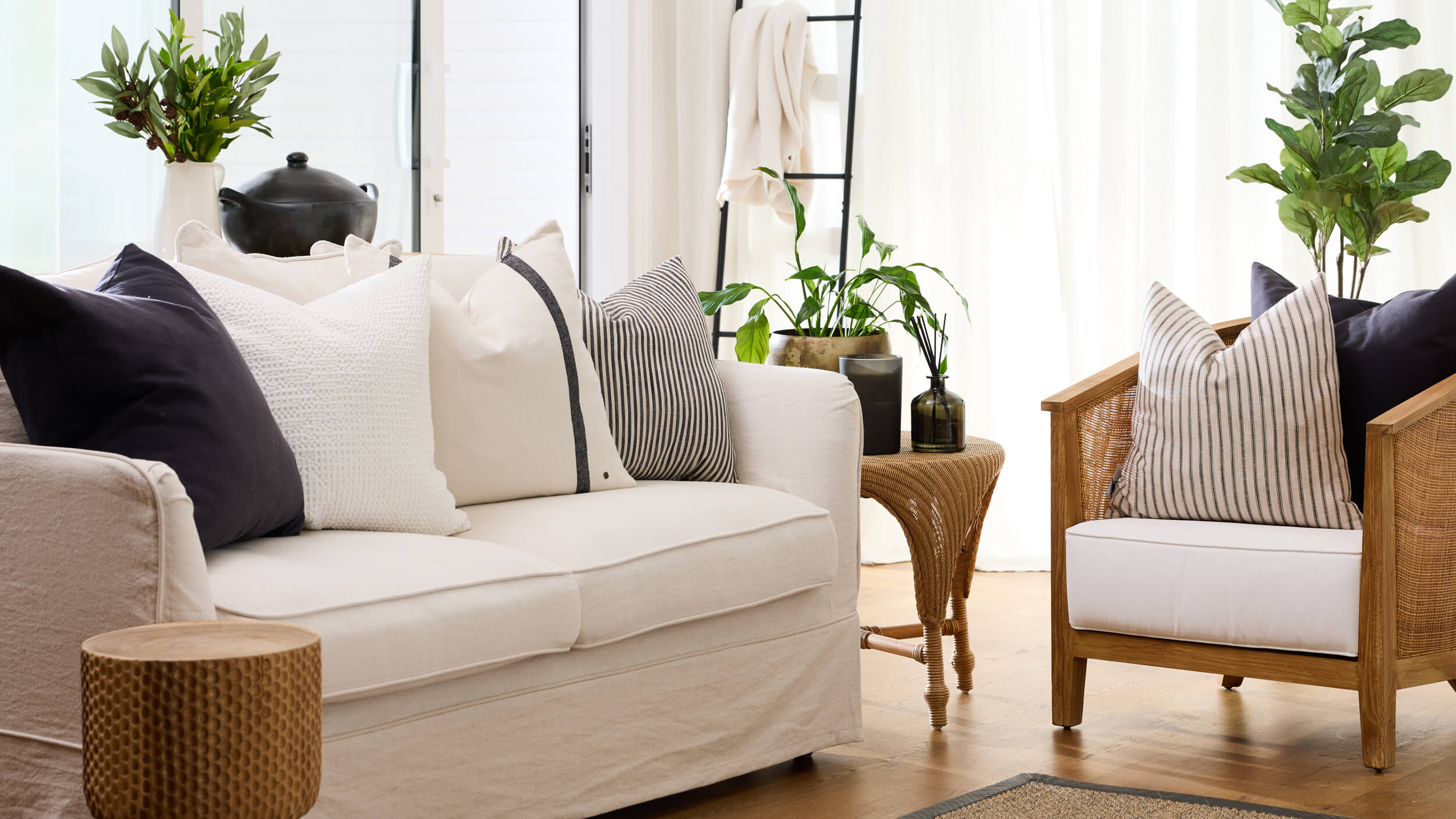 Royal Doulton Define living room with white and charcoal cushions on neutral seating