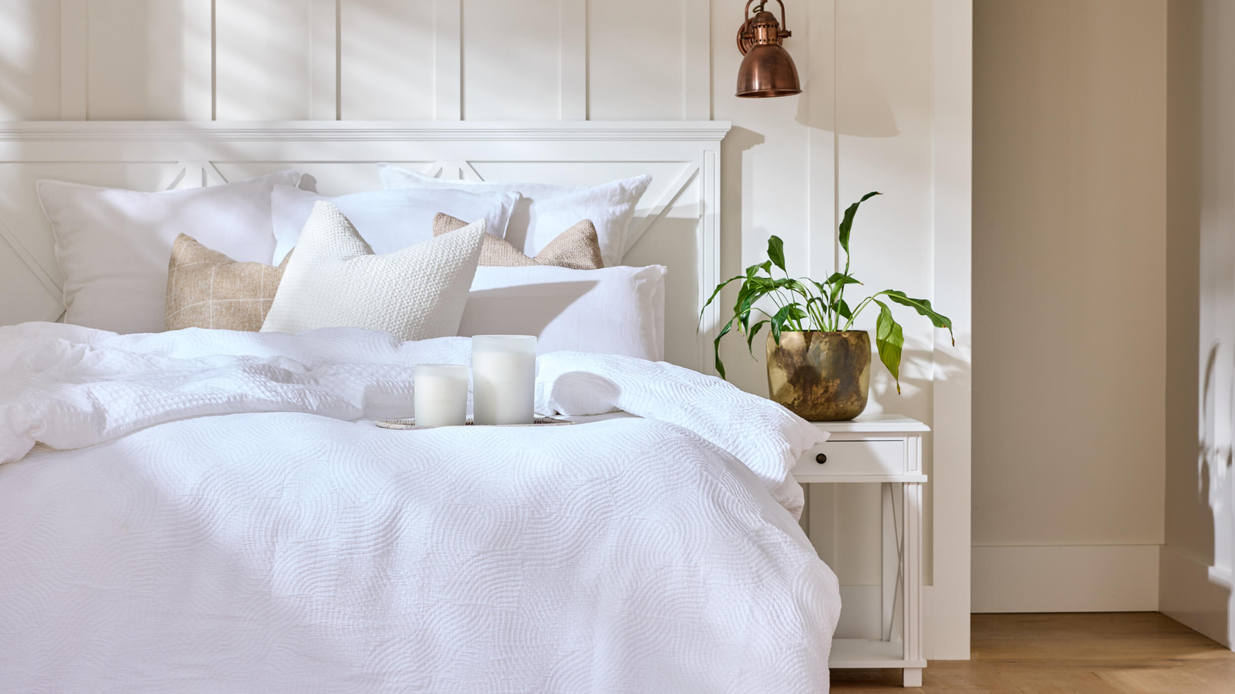 Royal Doulton Rest bedroom with white bedding, neutral cushions and candles